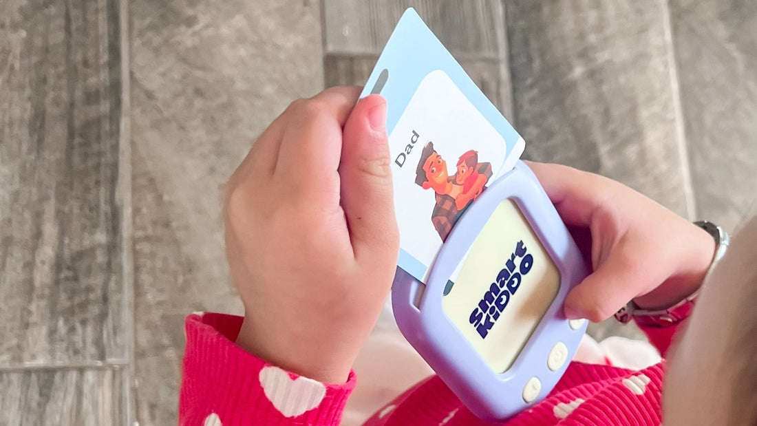 A toddler using the SmartKiddo Pocket Vocab learning toy to recognize and pronounce words, helping build confidence and early language skills