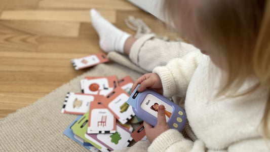 A young child using the SmartKiddo Pocket Vocab learning toy, engaging in vocabulary learning to boost confidence and communication skills