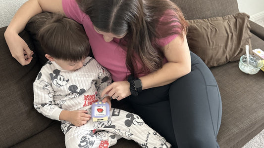 A mother and child using the SmartKiddo Pocket Vocab learning toy together, fostering focus, engagement, and early language development