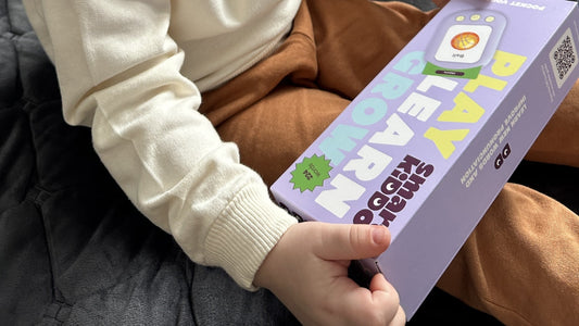 A child holding a SmartKiddo Pocket Vocab box, highlighting the benefits of screen-free learning for early childhood development
